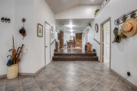 a view of a hallway with wooden floor and furniture
