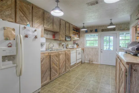 a kitchen with stainless steel appliances granite countertop a stove and a refrigerator