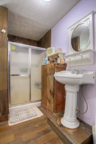 a bathroom with a sink toilet and shower