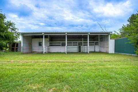 a view of a field with an trees in the background