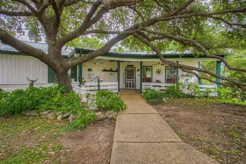 a view of a porch with chairs and backyard