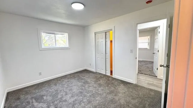 an empty room with a bathroom and a sink