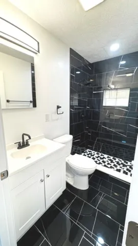 a bathroom with a sink toilet and shower