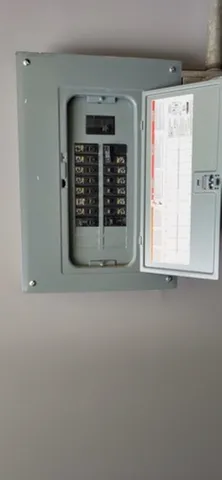 an empty room with windows and fireplace