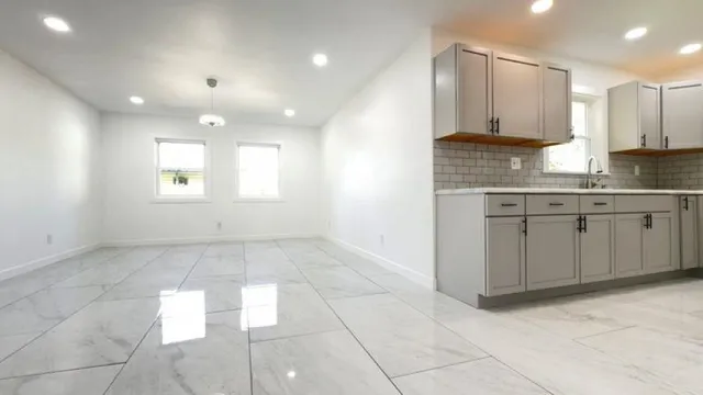 a view of a kitchen with a sink and cabinets