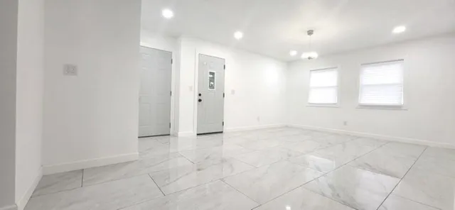 an empty room with windows and closet