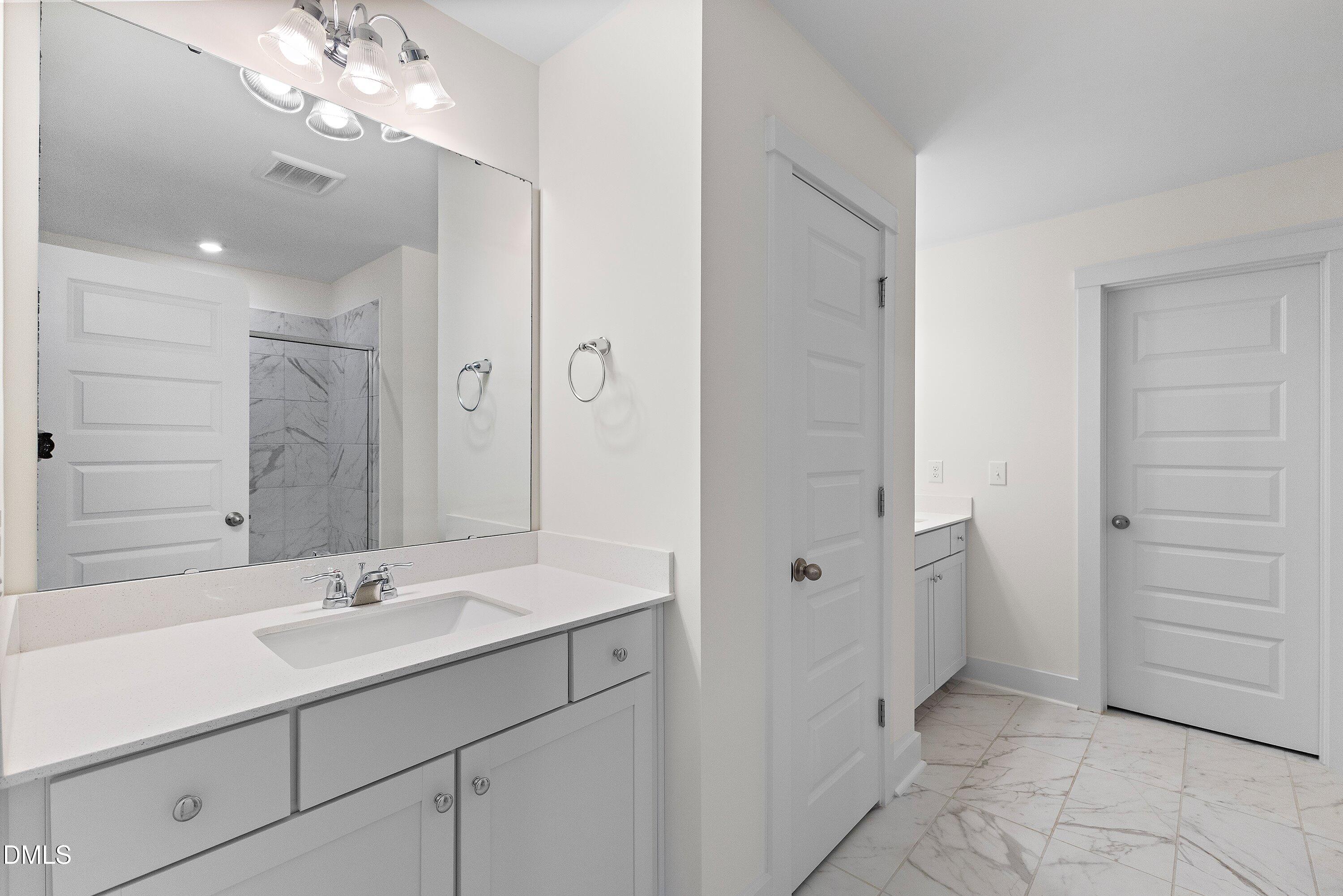 156 Sears Ridge Lane Morrisville, NC 27560 - Photo 22 of 49 a bathroom with a sink vanity and a mirror
