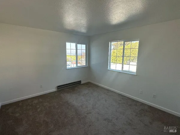 a bathroom with a granite countertop sink mirror vanity and toilet