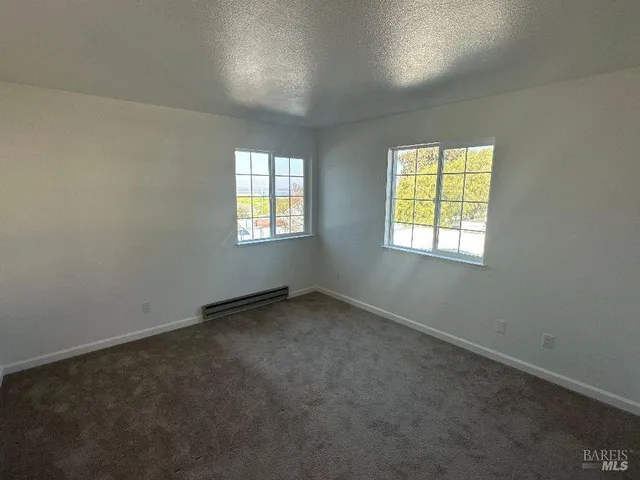 a bathroom with a granite countertop sink mirror vanity and toilet