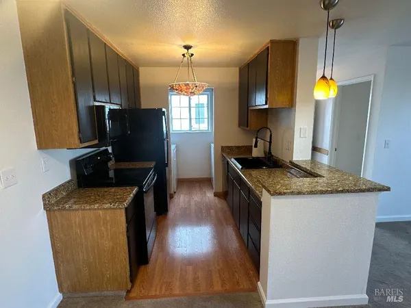 a kitchen with stainless steel appliances granite countertop a stove and a sink
