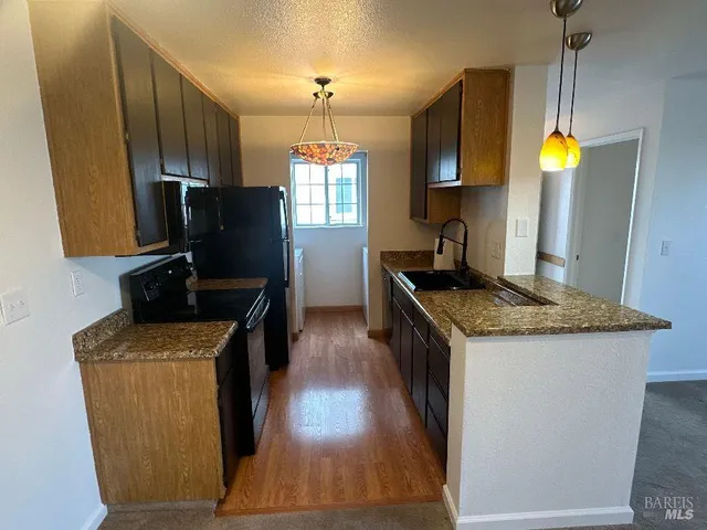 a kitchen with stainless steel appliances granite countertop a stove and a sink