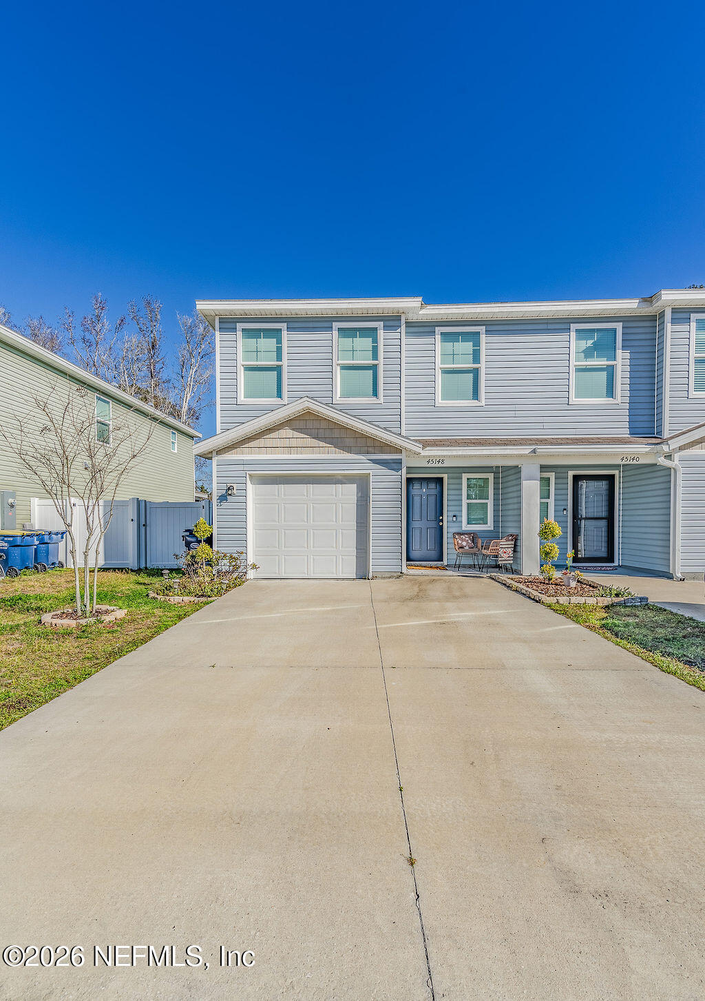 a front view of a building with a yard