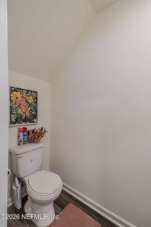 a bathroom with a toilet a sink and a mirror