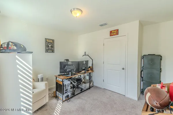 a room that has a bed and a chair in it