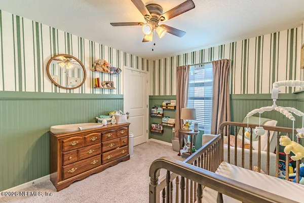 a bedroom with furniture and a window