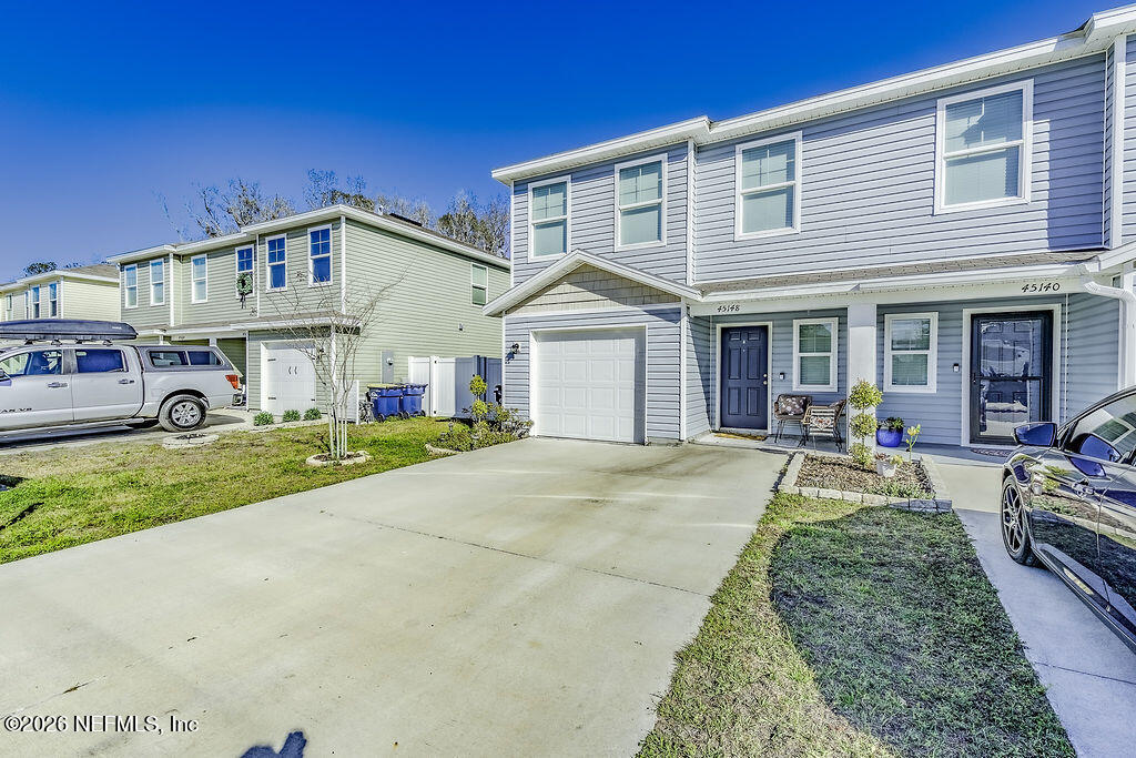 45148 Red Brick Drive Callahan, FL 32011 - Photo 2 of 32 a front view of a house with a yard and garage