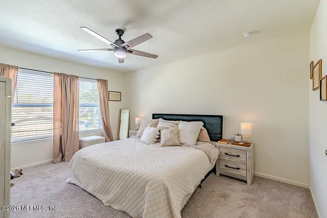 a view of walk in closet with clothes