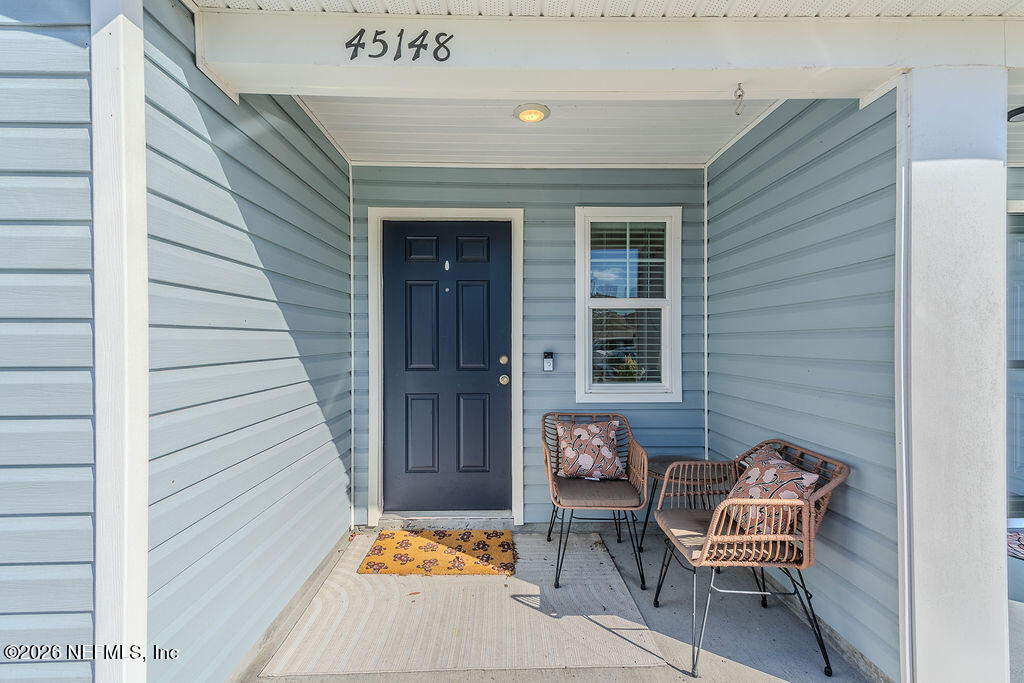 45148 Red Brick Drive Callahan, FL 32011 - Photo 4 of 32 a wooden bench sitting in front of a door