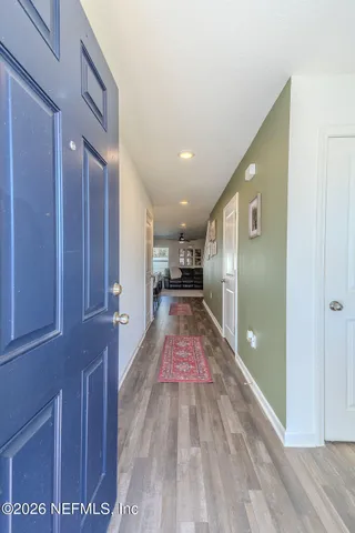 a view of gallery with wooden floor