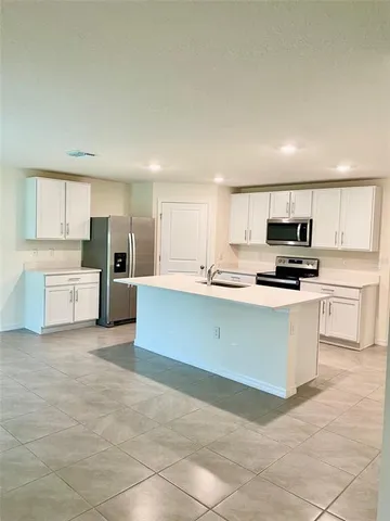 a large kitchen with cabinets and stainless steel appliances
