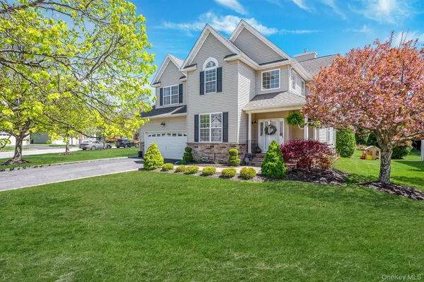 a front view of house with yard and green space