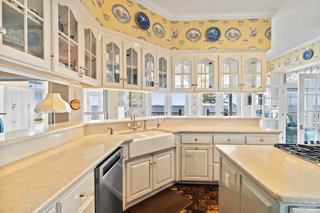 a kitchen with stainless steel appliances granite countertop a sink and cabinets