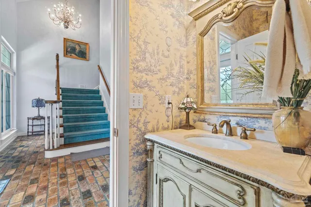 a spacious bedroom with a bed and a chandelier