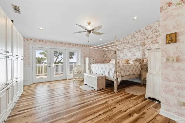 a bed sitting in a bedroom next to a window