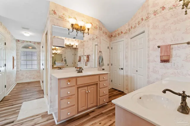 a bedroom with a bed and a ceiling fan