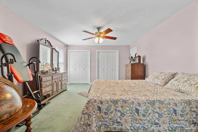 an aerial view of residential houses with outdoor space and trees