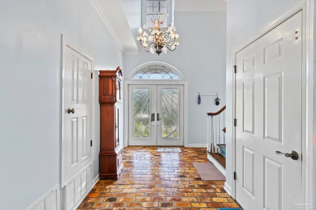 a spacious bedroom with a bed and glass windows