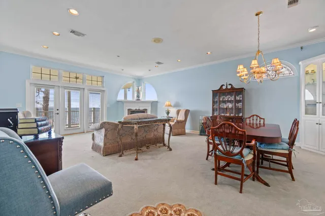 a view of a kitchen that has a lot of white cabinets and wooden floor