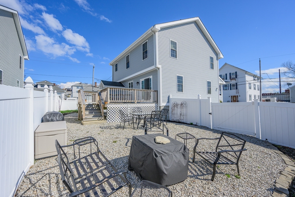 138 Sprague Street Fall River, MA 02724 - Photo 4 of 34 a view of a patio with couches and table and chairs with wooden floor