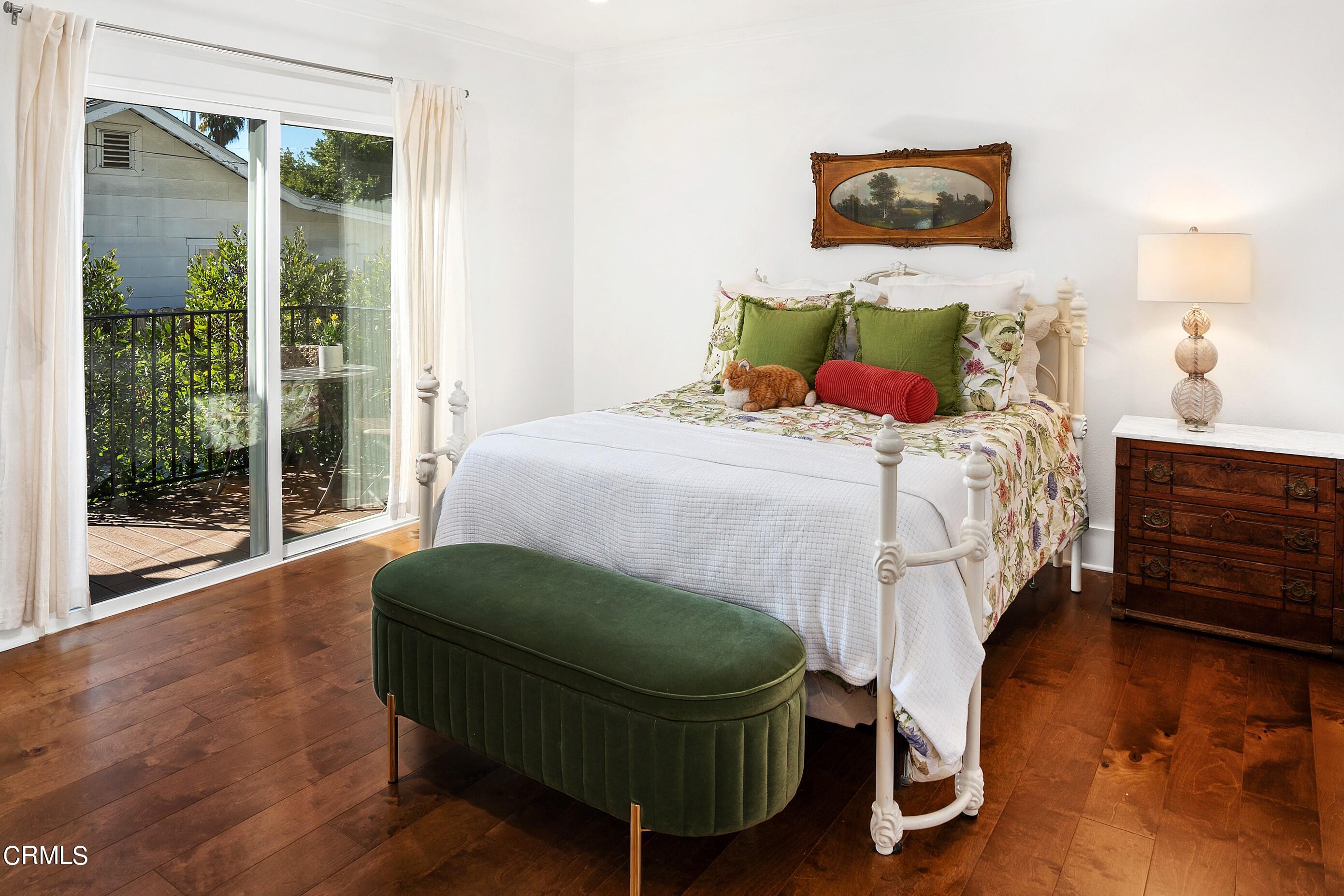 1465 Wesley Avenue Pasadena, CA 91104 - Photo 8 of 11 a bedroom with a bed mirror and window