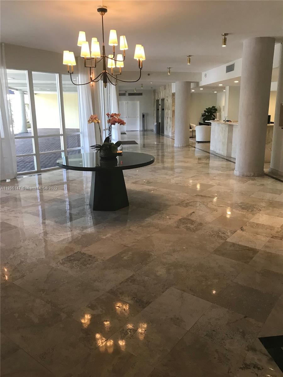 2351 Douglas Road, Unit 605 Miami, FL 33145 - Photo 2 of 10 a lobby with a couch and chandelier