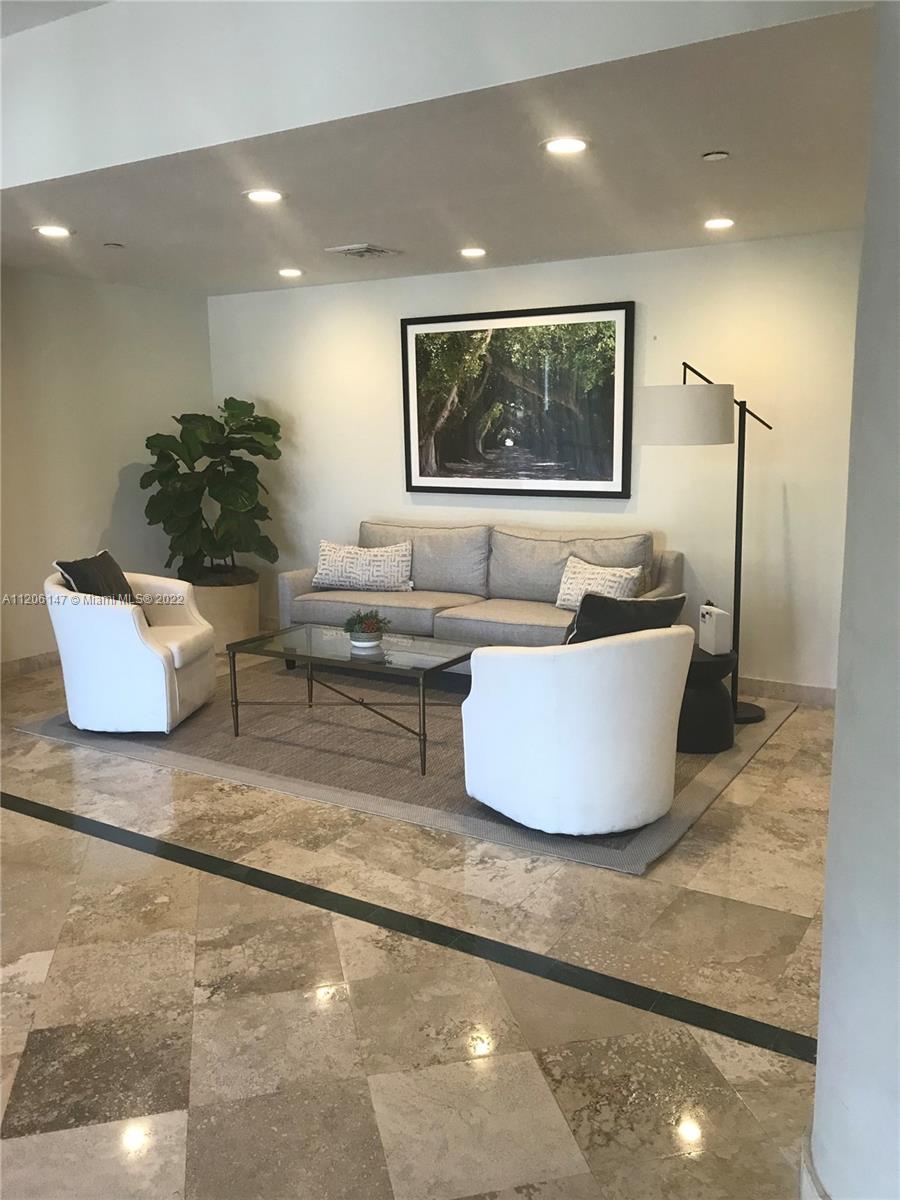 2351 Douglas Road, Unit 605 Miami, FL 33145 - Photo 3 of 10 a white room with a large window and a chandelier
