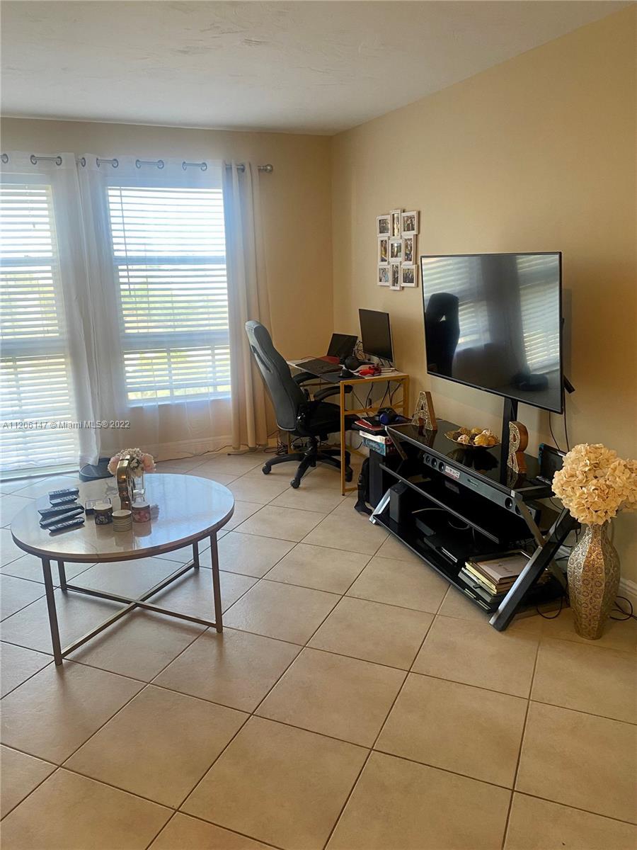 2351 Douglas Road, Unit 605 Miami, FL 33145 - Photo 6 of 10 a living room with furniture and a flat screen tv