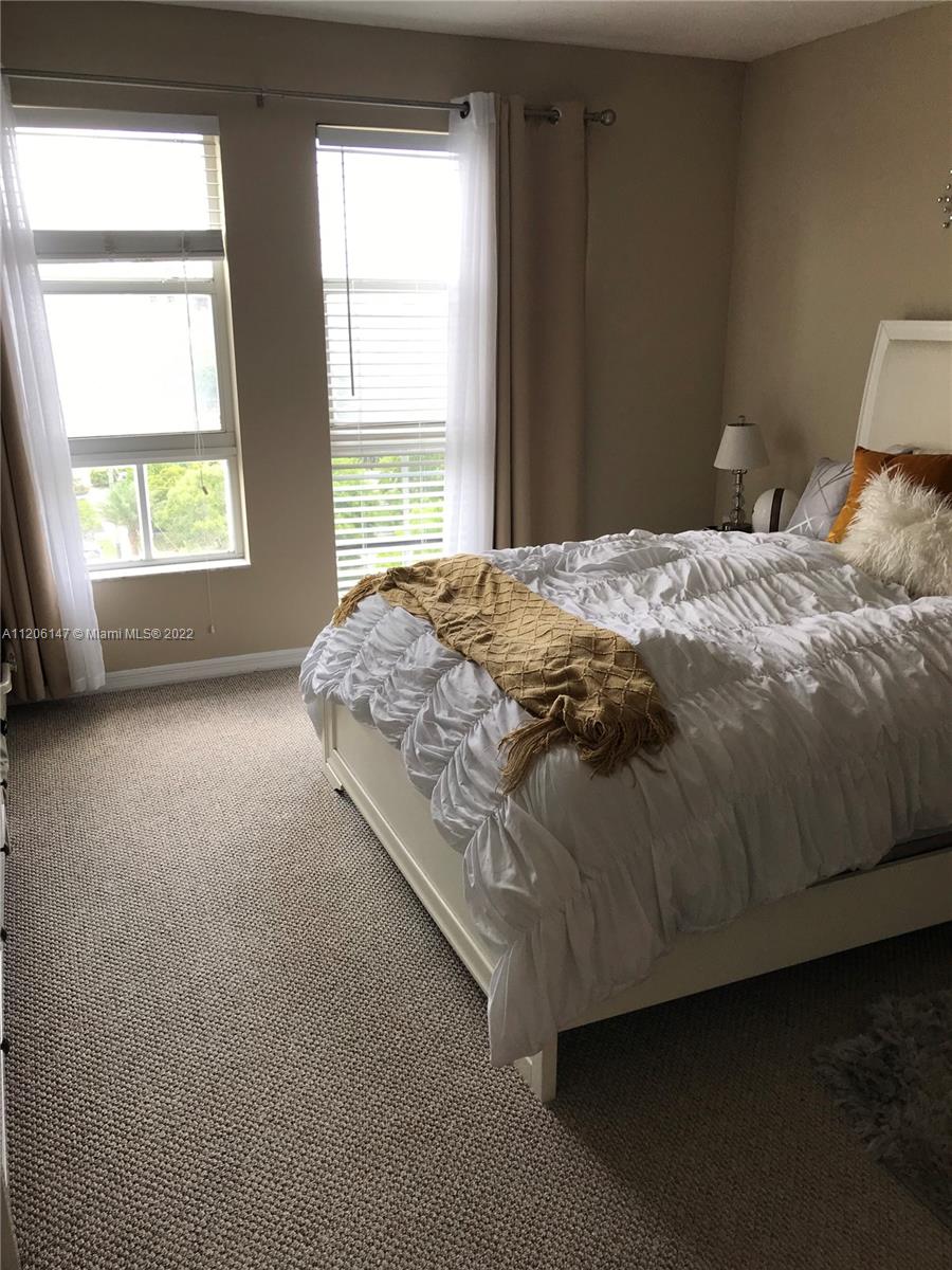 2351 Douglas Road, Unit 605 Miami, FL 33145 - Photo 10 of 10 a bed sitting in a bedroom next to a window