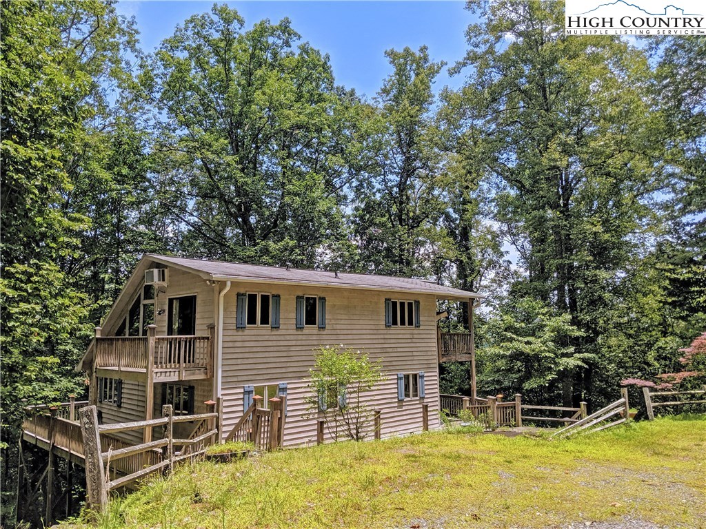 296 Grousemoor Road Deep Gap, NC 28618 - Photo 1 of 27 a view of a house with a backyard