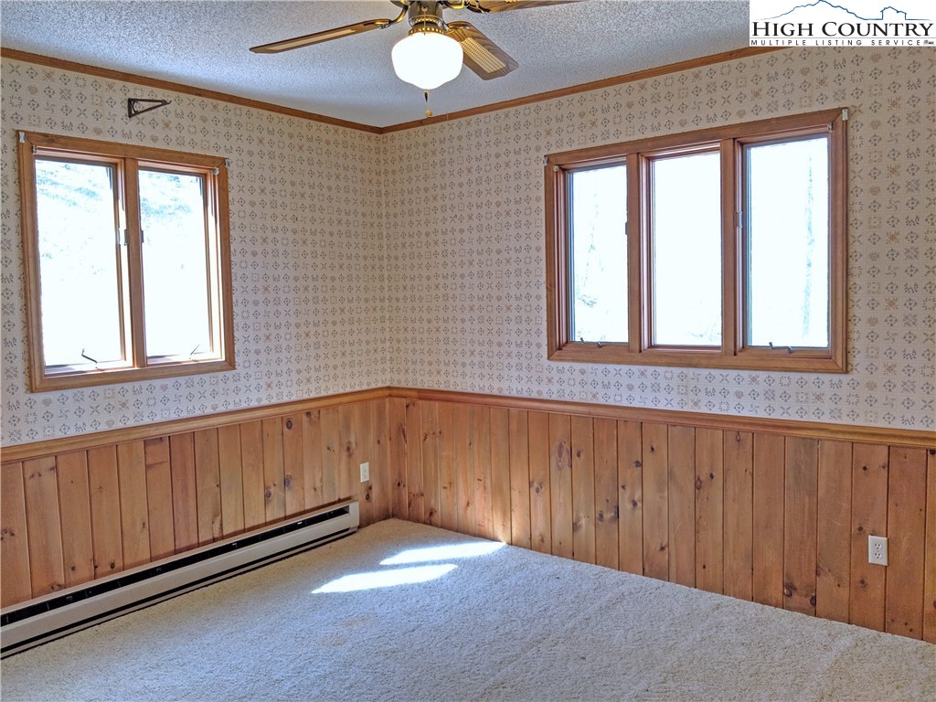 296 Grousemoor Road Deep Gap, NC 28618 - Photo 11 of 27 an empty room with windows