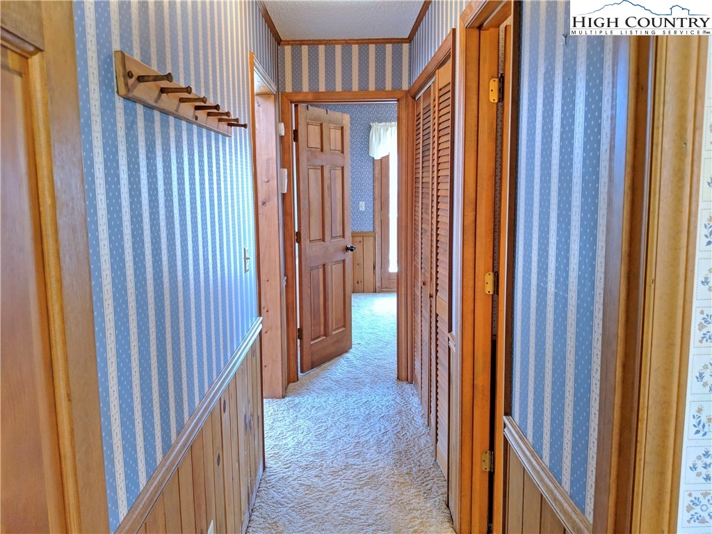 296 Grousemoor Road Deep Gap, NC 28618 - Photo 12 of 27 a view of a hallway with wooden shelves