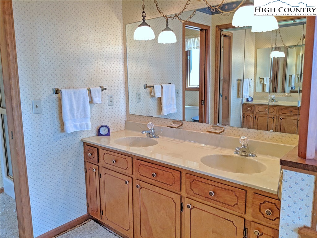 296 Grousemoor Road Deep Gap, NC 28618 - Photo 17 of 27 a bathroom with a sink and a mirror