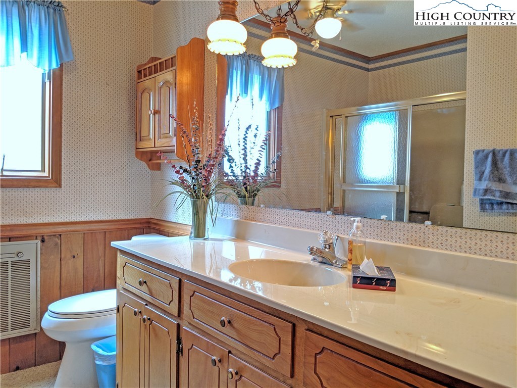 296 Grousemoor Road Deep Gap, NC 28618 - Photo 10 of 27 a bathroom with a sink a toilet and a mirror