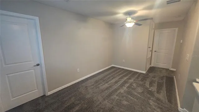 a view of an empty room with a mirror