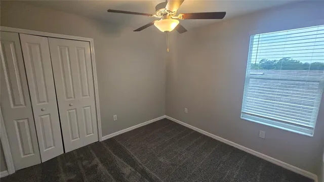 a view of an empty room with a fan