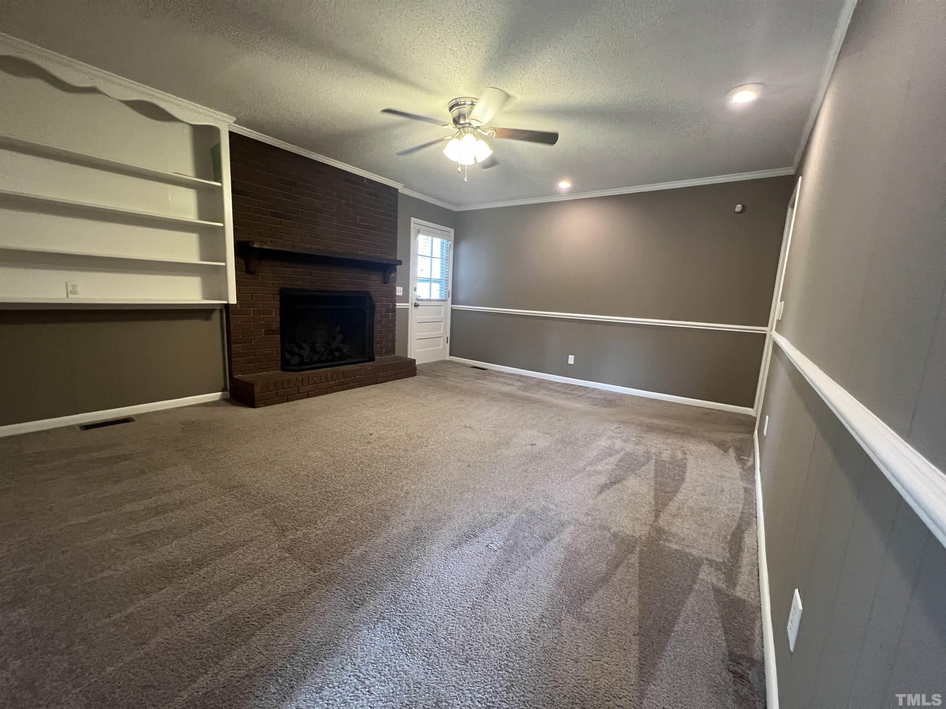 104 Marion Drive Erwin, NC 28339 - Photo 11 of 28 a view of an empty room with a fireplace and a window
