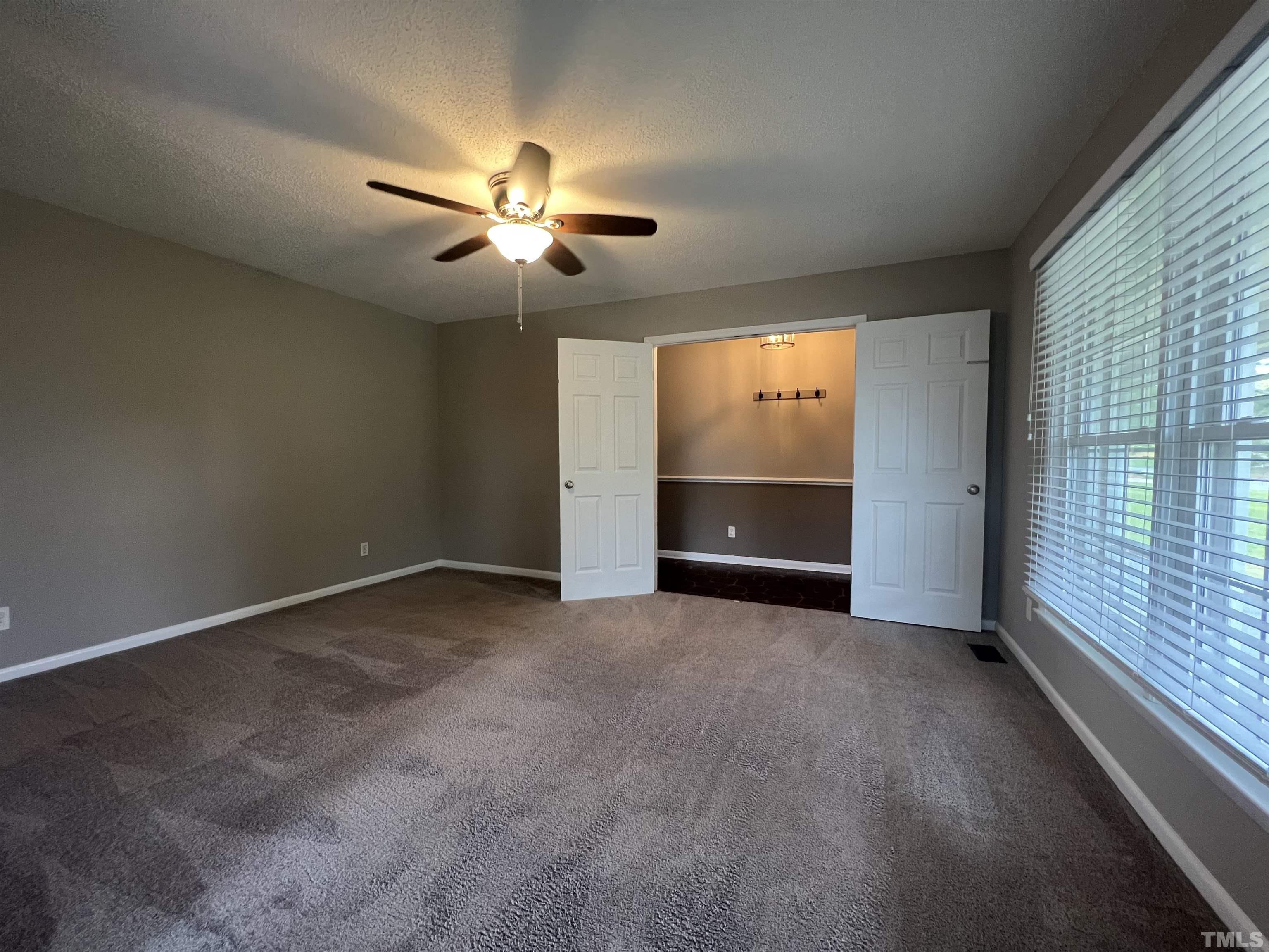 104 Marion Drive Erwin, NC 28339 - Photo 14 of 28 an empty room with windows and fan