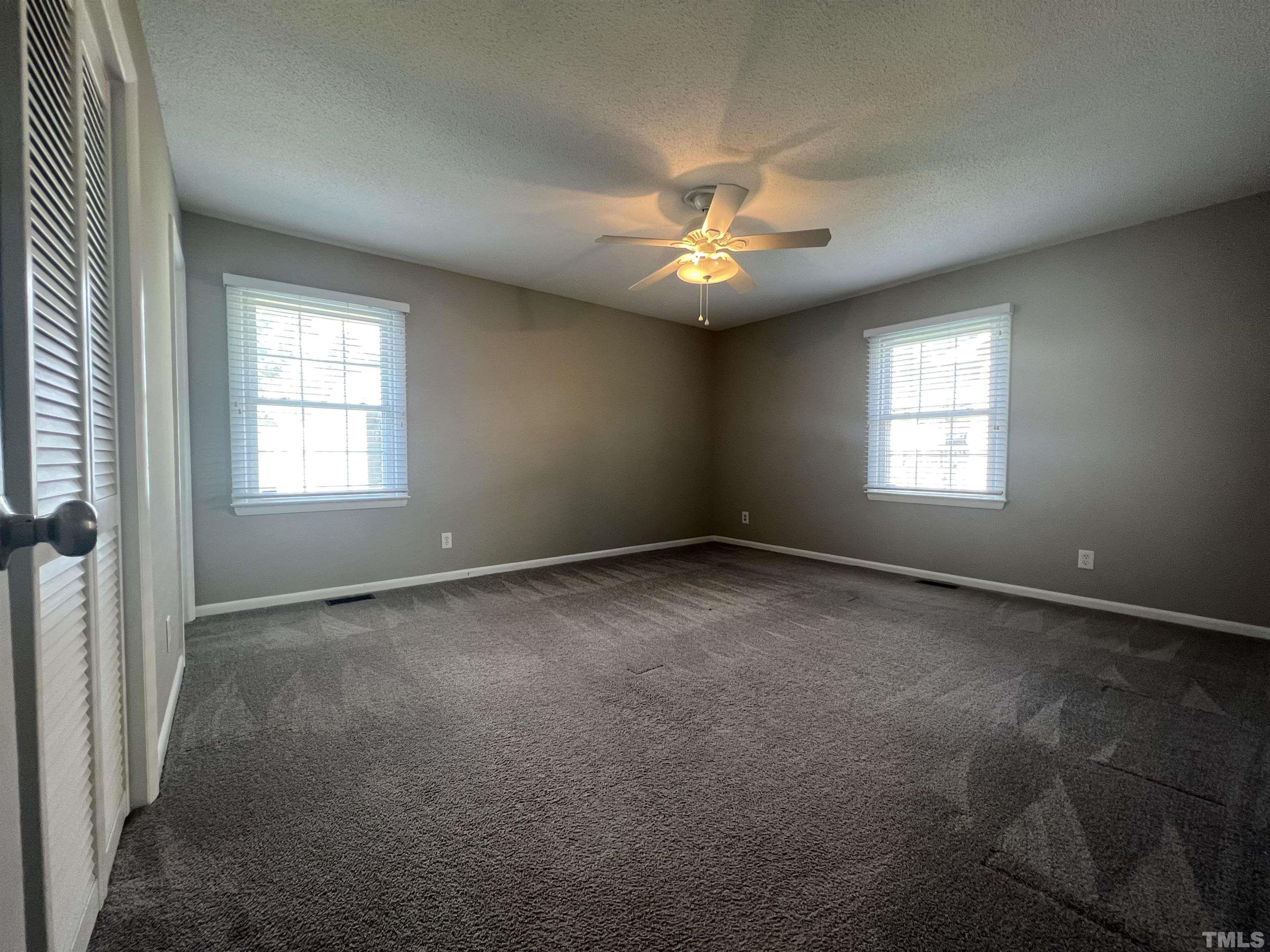 104 Marion Drive Erwin, NC 28339 - Photo 19 of 28 an empty room with a window and a fan