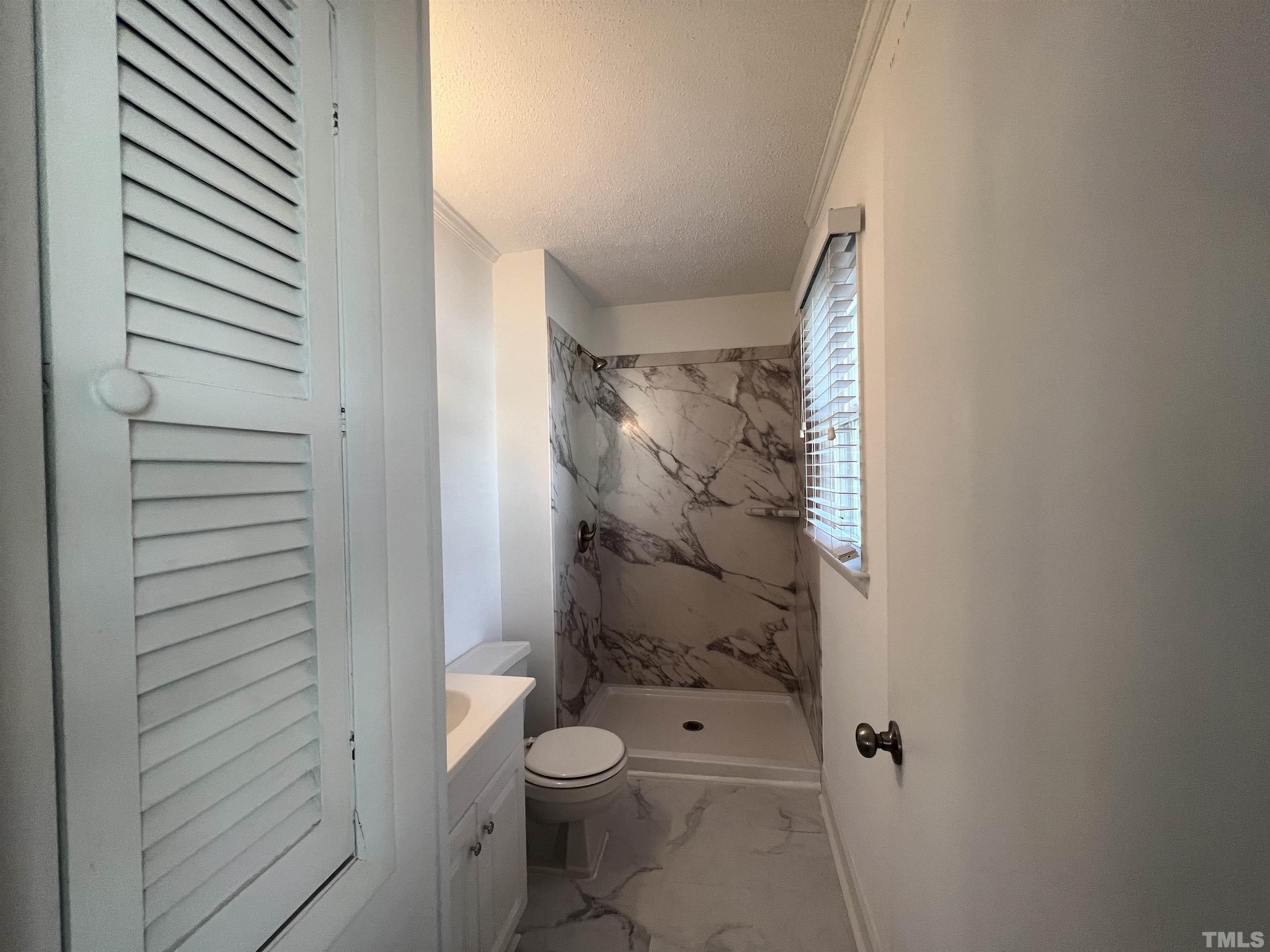 104 Marion Drive Erwin, NC 28339 - Photo 20 of 28 a bathroom with a toilet and a shower