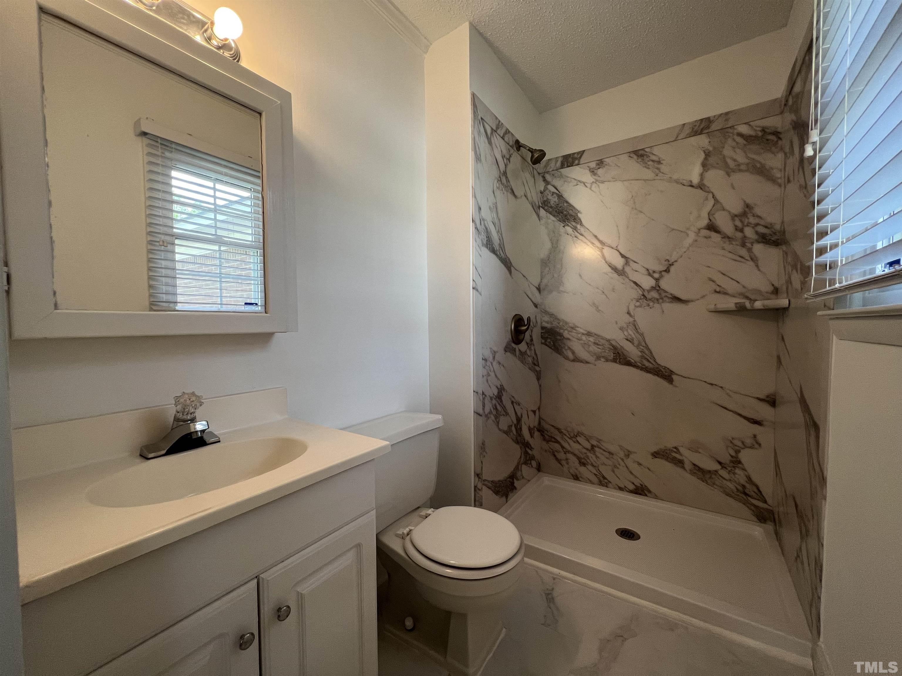104 Marion Drive Erwin, NC 28339 - Photo 21 of 28 a bathroom with a sink toilet and shower
